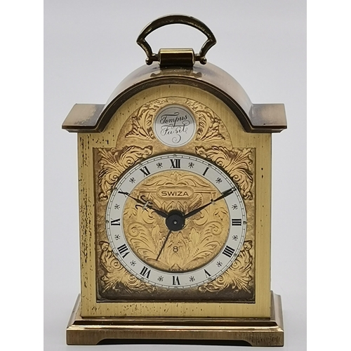 78 - A miniature brass cased alarm clock by Swiza, with engraved gilt metal face, the brushed steel chapt... 