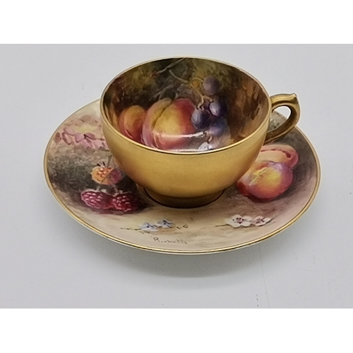 86 - A Royal Worcester gilded fruit and flower decorated cabinet tea cup and saucer, the cup by Frank Rob... 