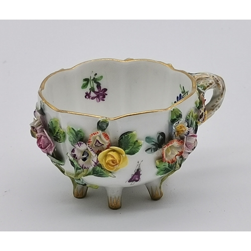 88 - A mid-late 19th Century floral encrusted teacup and saucer by Meissen, with gilt rims and twisted ha... 