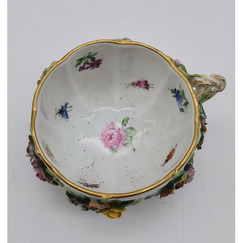 88 - A mid-late 19th Century floral encrusted teacup and saucer by Meissen, with gilt rims and twisted ha... 