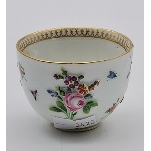 88 - A mid-late 19th Century floral encrusted teacup and saucer by Meissen, with gilt rims and twisted ha... 