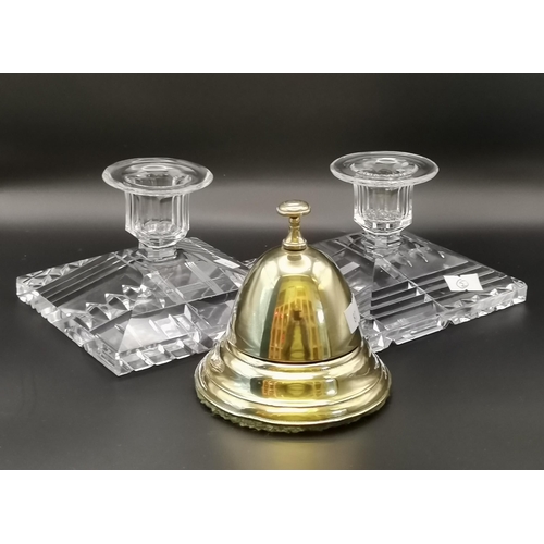 263 - A pair of pressed glass square candlesticks with decoratively sliced bases; together with a brass co... 