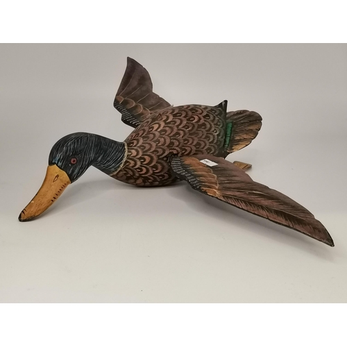 281 - Three naïve wooden decoy ducks, carved and painted. (3) Largest 39cm long