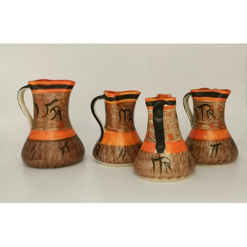 310 - Myott, Son & Co., a collection of assorted Art Deco pottery comprising a set of four sack jugs, hand... 