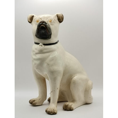 318 - A collection of Staffordshire dogs, comprising two pairs of Pekingese mantel dogs, a seated pug, and... 