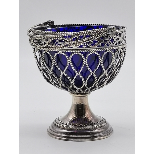 338 - A small group of assorted silver-plated wares, including an ovoid swing-handled sugar basket with bl... 