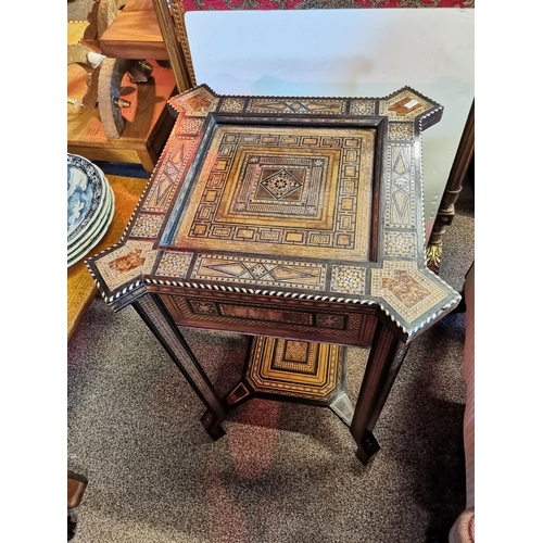 722 - A Moorish marquetry side table, square with ornate hardwood and ivory inlay, on stepped square legs ... 