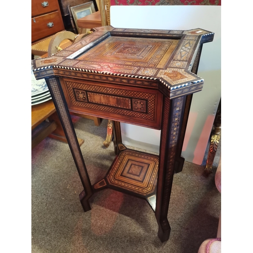 722 - A Moorish marquetry side table, square with ornate hardwood and ivory inlay, on stepped square legs ... 