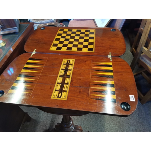 726 - A mahogany fold-over games table, the rounded rectangular top with inset gilt-tooled green leather w... 