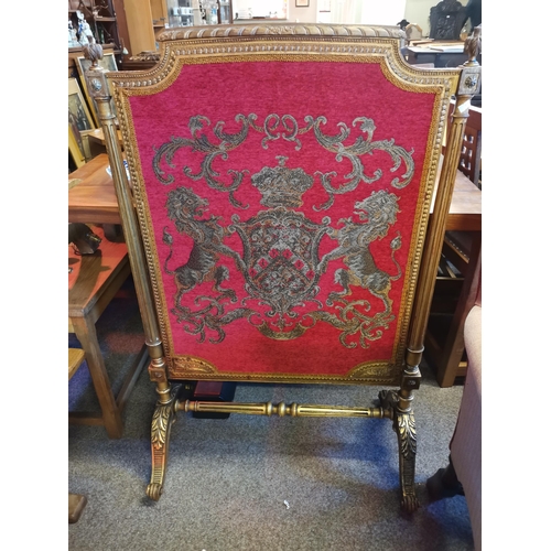 728 - A Louis XVI style carved giltwood and embroidered firescreen, 19th Century, decorated with lions ram... 