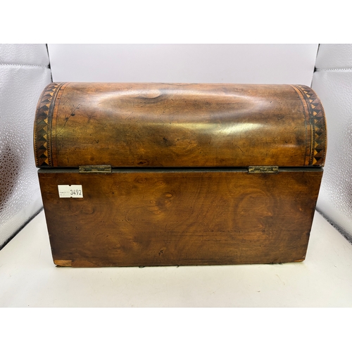 21 - A Victorian burr walnut tea caddy, dome-topped, with inlaid decoration, two internal compartments wi... 