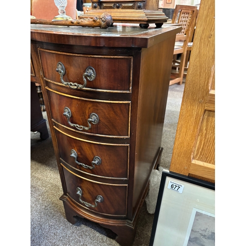 725 - A reproduction mahogany serpentine kneehole desk, the shaped top with gilt-tooled green leather writ... 