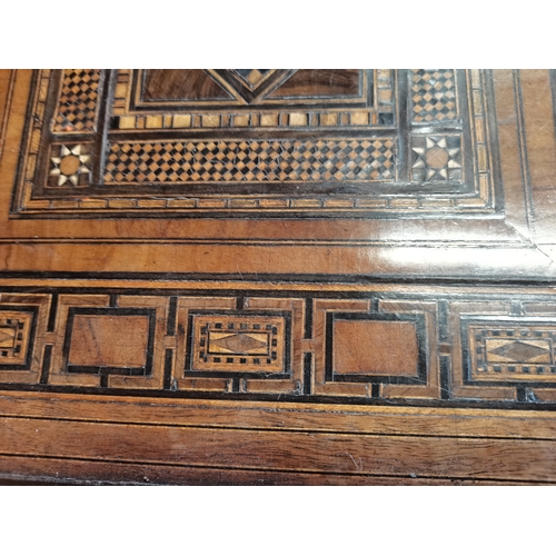 722 - A Moorish marquetry side table, square with ornate hardwood and ivory inlay, on stepped square legs ... 