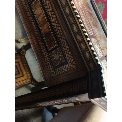 722 - A Moorish marquetry side table, square with ornate hardwood and ivory inlay, on stepped square legs ... 