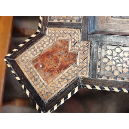 722 - A Moorish marquetry side table, square with ornate hardwood and ivory inlay, on stepped square legs ... 