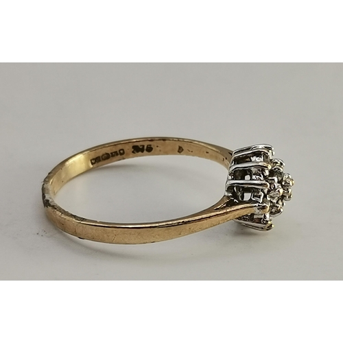 433A - An 18 carat gold and platinum white stone cluster ring, the seven round stones set as a flowerhead, ... 