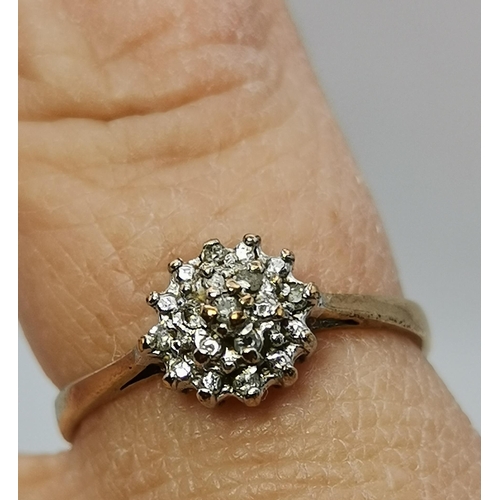 433A - An 18 carat gold and platinum white stone cluster ring, the seven round stones set as a flowerhead, ... 