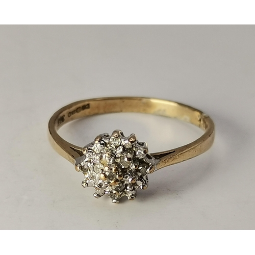 433A - An 18 carat gold and platinum white stone cluster ring, the seven round stones set as a flowerhead, ... 