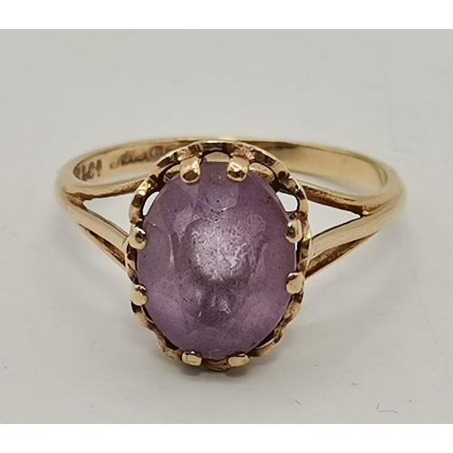 434A - Three 9 carat gold purple stone rings, the first claw-set with a cloudy oval stone to trifurcated op... 