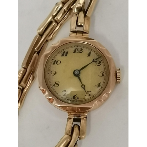 435 - A lady's 9 carat gold expanding bracelet wristwatch, the banded champagne circular dial with black A... 
