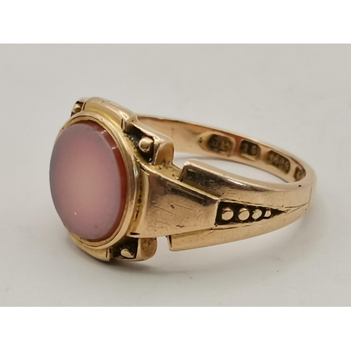 436 - A Victorian 15 carat gold signet ring, inset with plain circular hardstone matrix to a shaped mount ... 