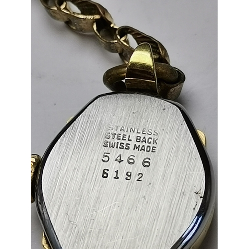 438 - A lady's 9 carat gold watch, the white circular dial signed Aoia 15 Jewels, with gilt Arabic numeral... 