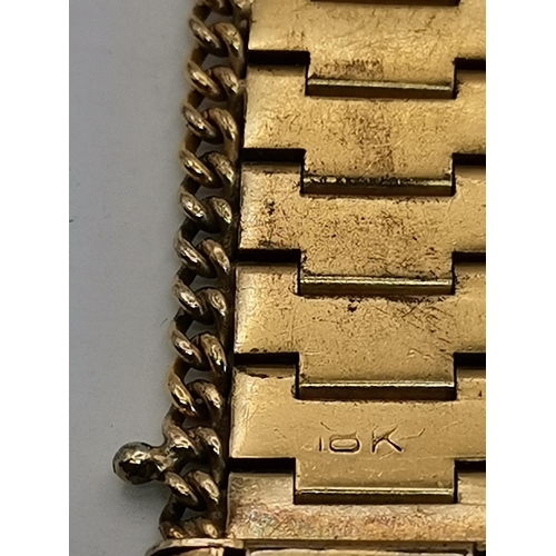 444 - A 9 carat gold hinge-opening bangle, engraved to front with scrolling foliate decoration, stamped 9C... 