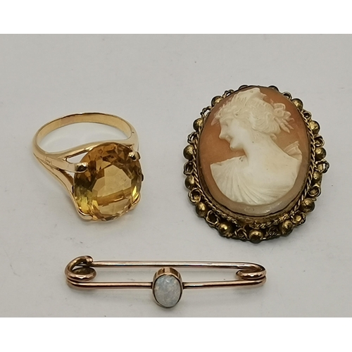 445A - An 18 carat gold citrine ring, the oval stone claw-mounted to trifurcated openwork shoulders in a ra... 