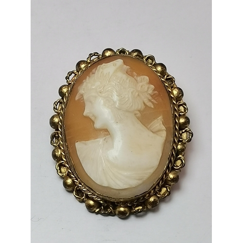 445A - An 18 carat gold citrine ring, the oval stone claw-mounted to trifurcated openwork shoulders in a ra... 