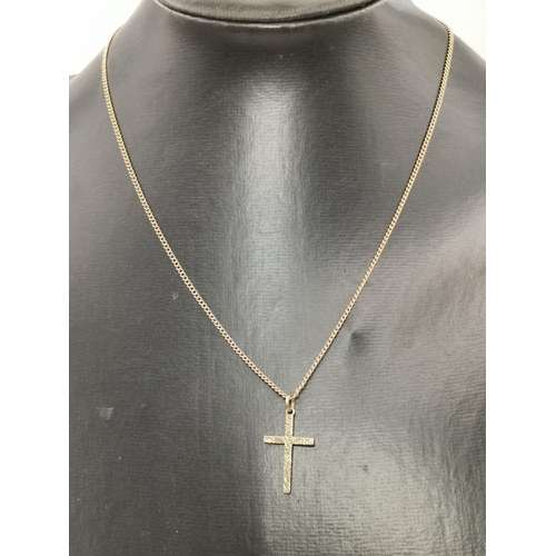 453A - A 9 carat gold crucifix pendant on chain, the cross with foliate engraving to front, inscription dat... 