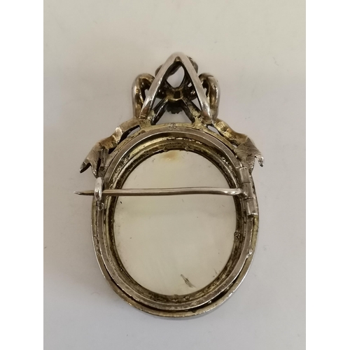 455 - A 19th Century Continental white metal enamelled mourning brooch, the oval plaque decorated with two... 