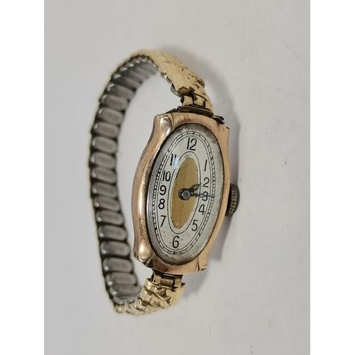 484 - A lady's Art Deco 9 carat gold wristwatch, the white oval dial with a gilded centre, black Arabic nu... 