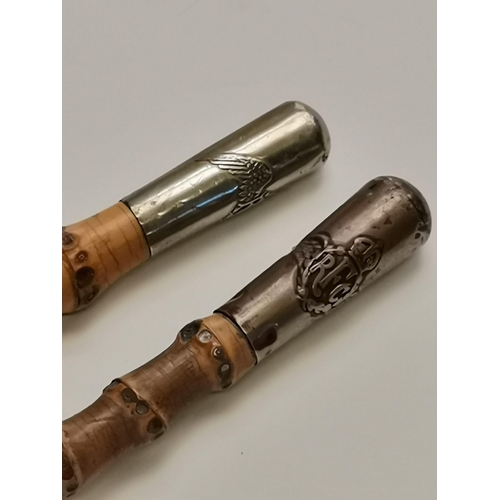 496 - Two First World War bamboo Royal Flying Corps swagger sticks, the white-metal caps each with RFC win... 