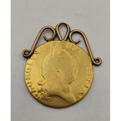 513A - A George III 1787 spade guinea pendant, with unmarked yellow metal fixed scroll mount. 8.9g gross