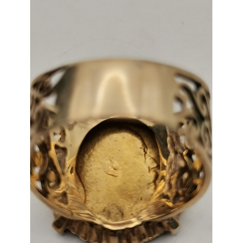 521A - A 9 carat gold-mounted Edward VII 1903 half sovereign ring, the coin claw-mounted to a broad shank w... 