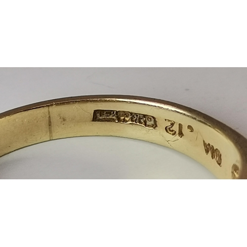 528 - A 9 carat gold three stone ring, the central blue round stone flanked by two round white stones, cla... 