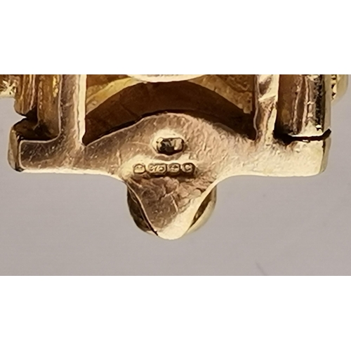 529A - A 9 carat gold and eight stone garnet fancy link bracelet, the oval stones set to ornate scrolling l... 