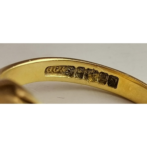 530A - An 18 carat gold signet ring, the plain oval top with shaped edge to tapering shoulders, hallmarked ... 