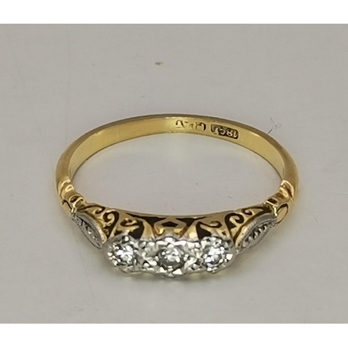 534A - An 18 carat gold and platinum solitaire ring, the single circular white stone to feather-decorated p... 