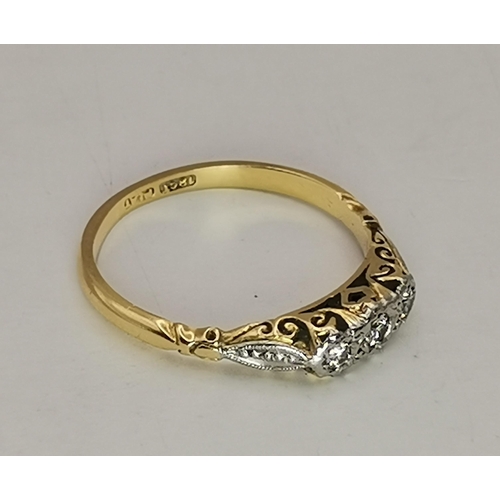 534A - An 18 carat gold and platinum solitaire ring, the single circular white stone to feather-decorated p... 