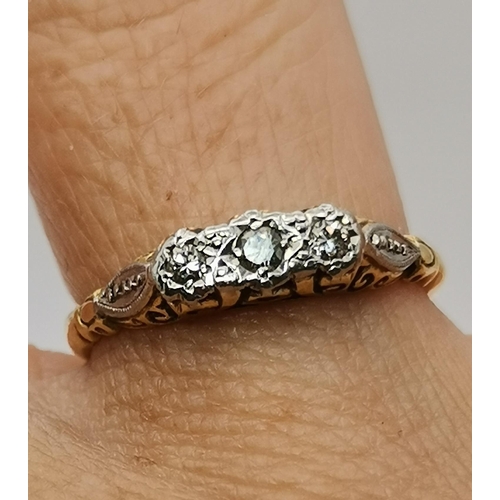 534A - An 18 carat gold and platinum solitaire ring, the single circular white stone to feather-decorated p... 