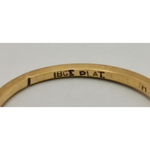 534A - An 18 carat gold and platinum solitaire ring, the single circular white stone to feather-decorated p... 