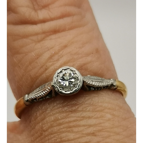 534A - An 18 carat gold and platinum solitaire ring, the single circular white stone to feather-decorated p... 