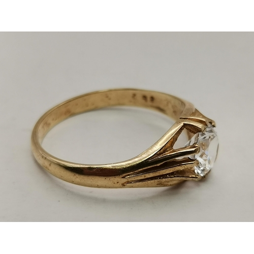 535A - A 9 carat gold white stone solitaire dress ring, the large glass (CZ?) stone claw-set to a grooved a... 