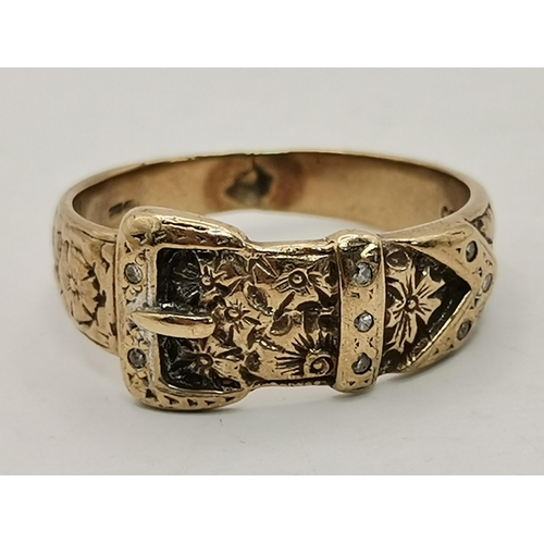 545 - A 9 carat gold and diamond buckle ring, with chased foliate and floral decoration, set with eight sm... 