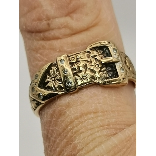 545 - A 9 carat gold and diamond buckle ring, with chased foliate and floral decoration, set with eight sm... 