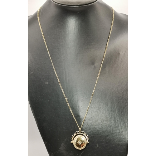 546 - A 9 carat gold swivel locket pendant to a fine Figaro chain; together with a 9 carat gold fouled anc... 