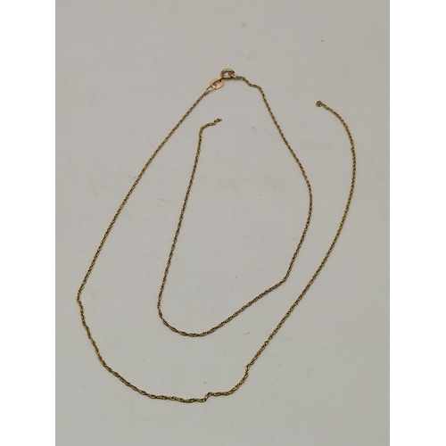 546 - A 9 carat gold swivel locket pendant to a fine Figaro chain; together with a 9 carat gold fouled anc... 