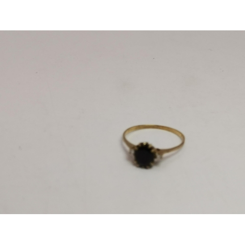 548A - A 9 carat gold five stone ring, with three graduated round blue stones spaced by two round white sto... 