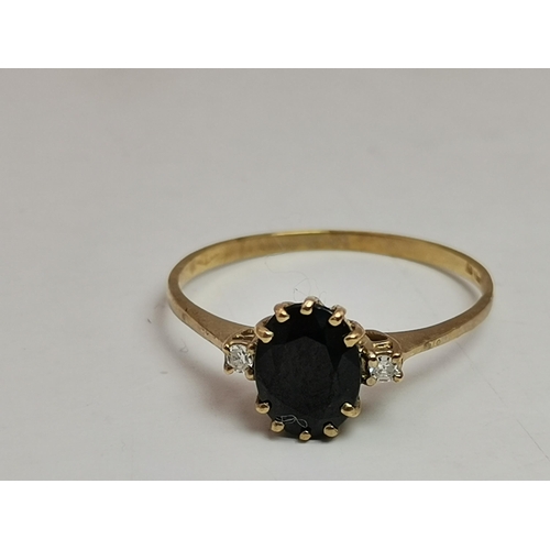 548A - A 9 carat gold five stone ring, with three graduated round blue stones spaced by two round white sto... 